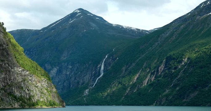 Geirangerfjord, Norway. Touristic Ship Ferry Boat Floating Liner Through Waters Of Geirangerfjorden In Spring Summer Day. Famous Norwegian Landmark And Popular Destination
