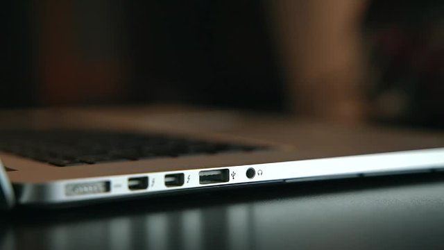 Man puts out usb stick out of the laptop