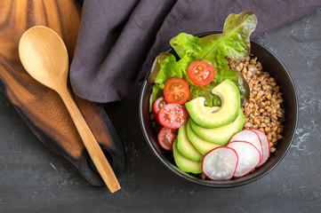 Healthy dish with buckwheat and vegetable salad. Buddha bowl. Balanced food. Delicious detox...