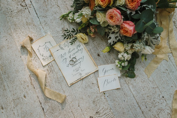 Graphic arts of beautiful wedding calligraphy cards with flower and chiffon bobbins on wood...