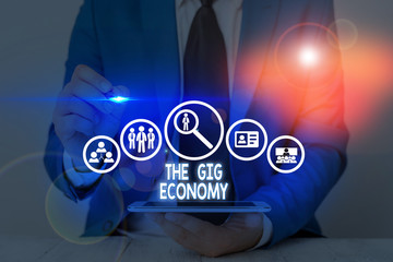 Writing note showing The Gig Economy. Business concept for Market of Shortterm contracts freelance...