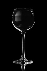 Wine glass on a black background in contrasting light