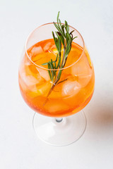 Aperol spritz cocktail glass on white backgorund with oranges. Top View.
