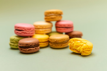 Colored tasty  macaroons over a green background