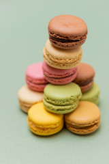 Colored tasty  macaroons over a green background