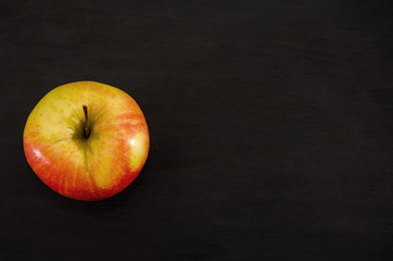red apple on a black background. View from above.