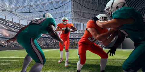 American football players in professional stadium.