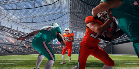 American football players in professional stadium.