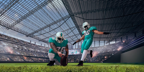 Obraz na płótnie Canvas American football players in professional stadium.