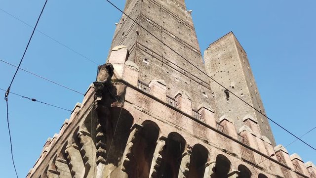Perspective bottom view of Asinelli tower, famous for its big inclination from the base, in the historic center of Bologna city, Italy.