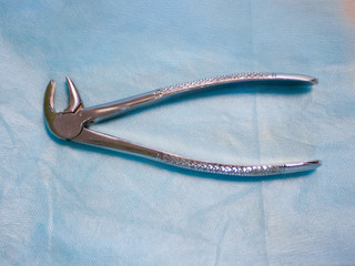 Dental tool for removing teeth. close top view. removal of a tooth. Dental Pliers, Tooth Extraction