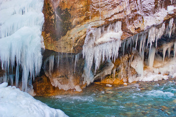 Chegem waterfalls in winter, icy water falls from the mountain