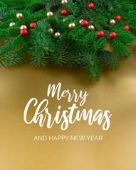Obraz na płótnie Canvas Merry Christmas and Happy New Year Sign with spruce branch. Christmas golden background with ornate spruce branch stock images. Elegant holiday background. Golden Christmas greeting card
