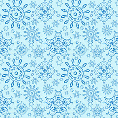 Seamless pattern with blue snowflakes and stars