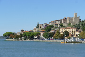 Passignano on Trasimeno Lake panorama from the port of the village built on a rocky spur around a...
