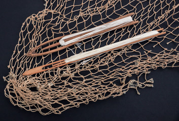 Old fishing net. Fishing net repair tools