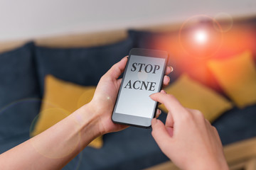 Word writing text Stop Acne. Business photo showcasing control the occurrence of inflamed sebaceous glands in the skin woman using smartphone office supplies technological devices inside home