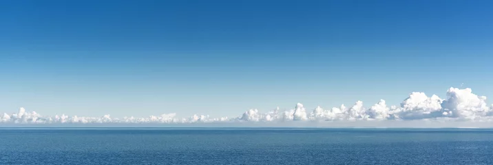 Fotobehang Sea. Sea horizon and clouds in the distance on a clear day. © Denis Rozhnovsky