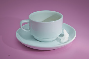 coffee cup over pink background . sugar .Glass cup isolated on a pink background with clipping path. Front view .