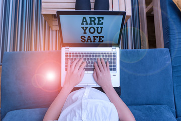 Writing note showing Are You Safe. Business concept for Free from danger Not anticipating any Harm Hurt physically woman laptop computer office supplies technological devices inside home