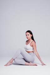 Athletic young woman doing yoga on a white background - the concept of a healthy lifestyle and a...