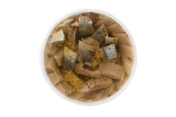 Marinated fish in a plastic container. Pieces of pickled herring in the package from the store on a white background.