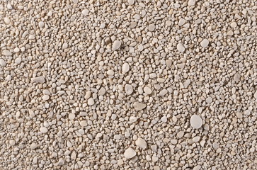 Pebbles on sea shore background and texture