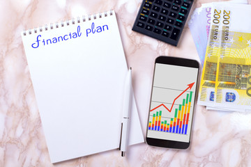Desktop with business charts, calculator and money. 52-week savings plan. Financial planner.