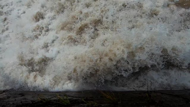 Slow motion looking down on flooded rapid river water