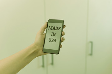 Writing note showing Made In Usa. Business concept for American brand United States Manufactured Local product woman using smartphone and technological devices inside the home