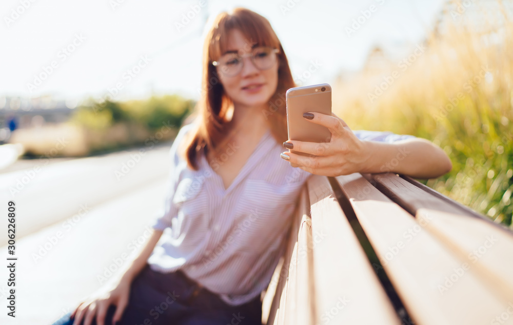 Aufkleber selective focus on female hand holding modern mobile phone and installing application for online com