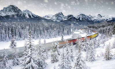 Long exposure of moving train in the snow near Banff National Park