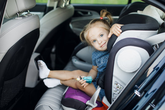 Cute little baby child sitting in car seat. Portrait of cute little baby child sitting in car seat. Safety concept.