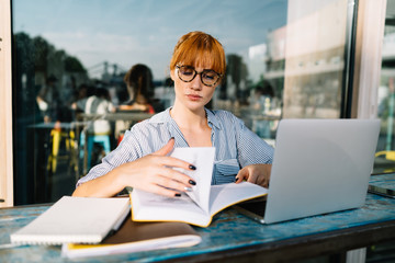Smart woman in eyeglasses for vision correction searching plan for university project in knowledge...