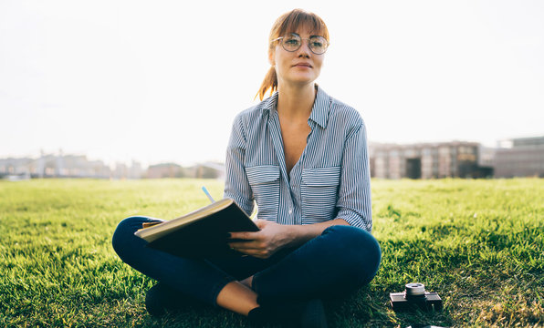 Contemplative female writer in classic eyeglasses thoughtful looking away while creating content text for best seller book, pensive woman student thinking on information from textbook for education