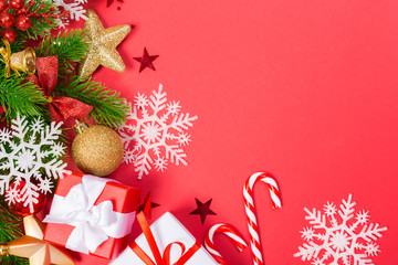 Christmas red background with herringbone and decor. Gold and red jewelry. Top view with space for...