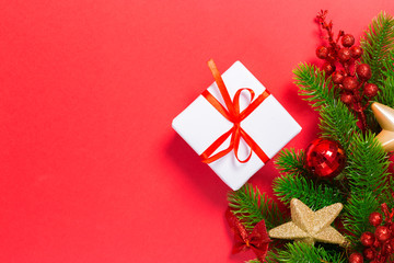 Christmas red background with herringbone and decor. Gold and red jewelry. Top view with space for copy.