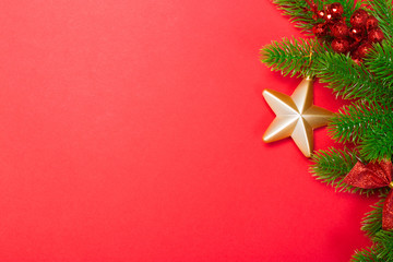 Christmas red background with herringbone and decor. Gold and red jewelry. Top view with space for copy.