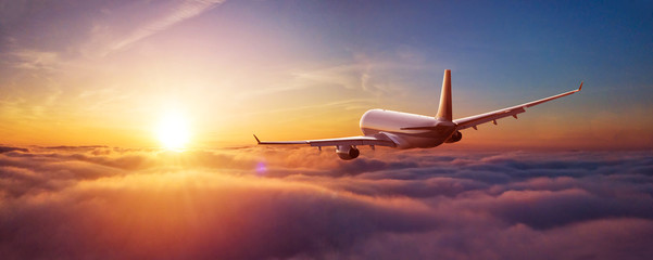 Fototapeta na wymiar Passengers commercial airplane flying above clouds