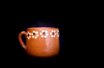 cup traditional clay mexican hand painted with floral pattern on black background