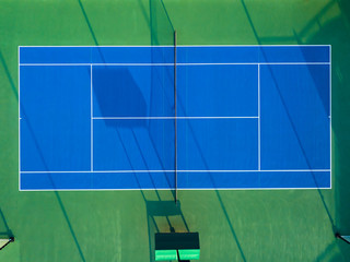 Aerial view 90 degrees vertical of blue tennis court