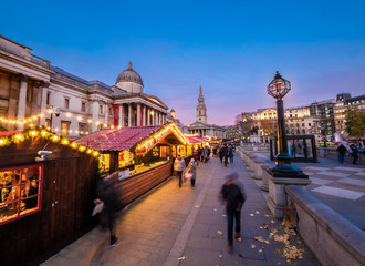 Fototapeta premium London, England, Uk - Christmas scene outdoors in Trafalgar square Market at blue hour in winter season