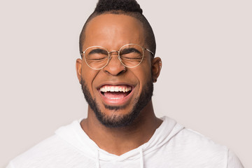 Funny African American man with healthy smile laughing close up
