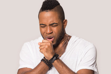 Unhealthy African American man coughing, suffering from flu or cold
