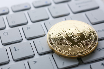 Coin crypto currency bitcoin lies on the keyboard