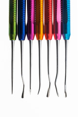 dental surgical raspor of metal and bright color on a white background