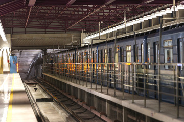 Underground train station with a view of tunnel entrance. Subway, public transportation concept.