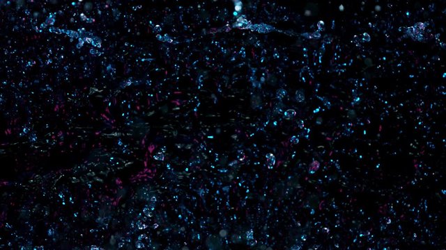 Super Slow Motion Abstract Shot of Splashing Neon Water at 1000fps. Filmed with High Speed Cinema Camera in 4K Resolution.