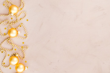Golden Christmas background. Beads with decorative balls and stars.
