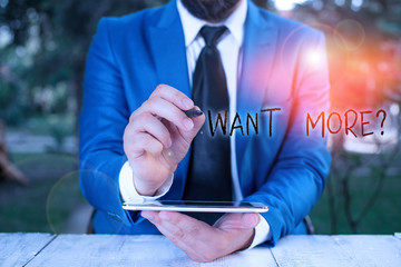Writing note showing Want Morequestion. Business concept for If you want something you feel a desire or a need for it Businessman pointing with pen in empty copy space